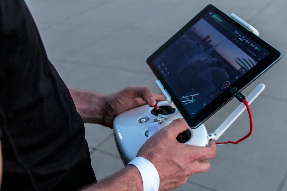 Drone pilot operating a controller with a tablet display