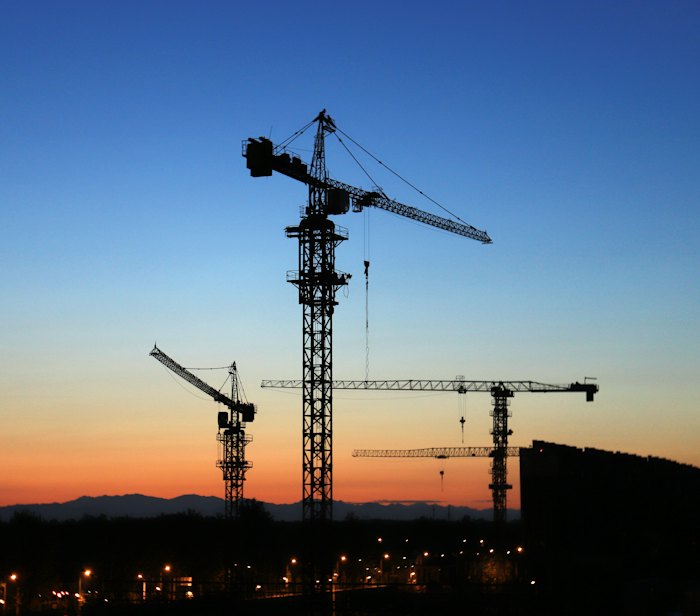 Tower cranes at sunset