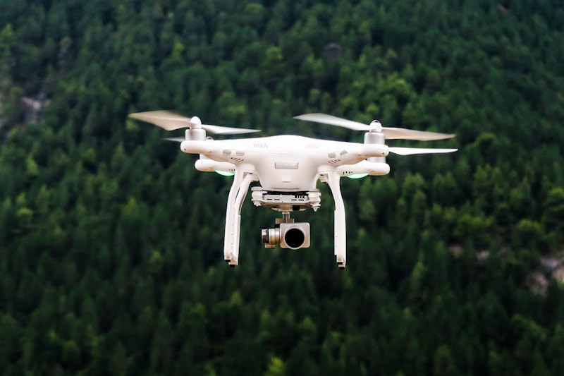 Survey drone in flight over forest